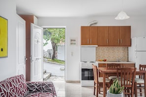 A modern kitchen with wooden cabinets, a stove, and a refrigerator.