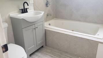 Jetted tub, hair dryer, towels, toilet paper