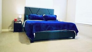 A bedroom with a bed, a nightstand, and a window. - Cozy townhome in old town north dogs, Bikes. (Fort Collins)
