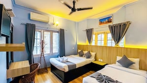 A hotel room with a bed, a desk, a chair, and a ceiling fan. - Hotel Rudrakshya Pokhara (Pokhara)