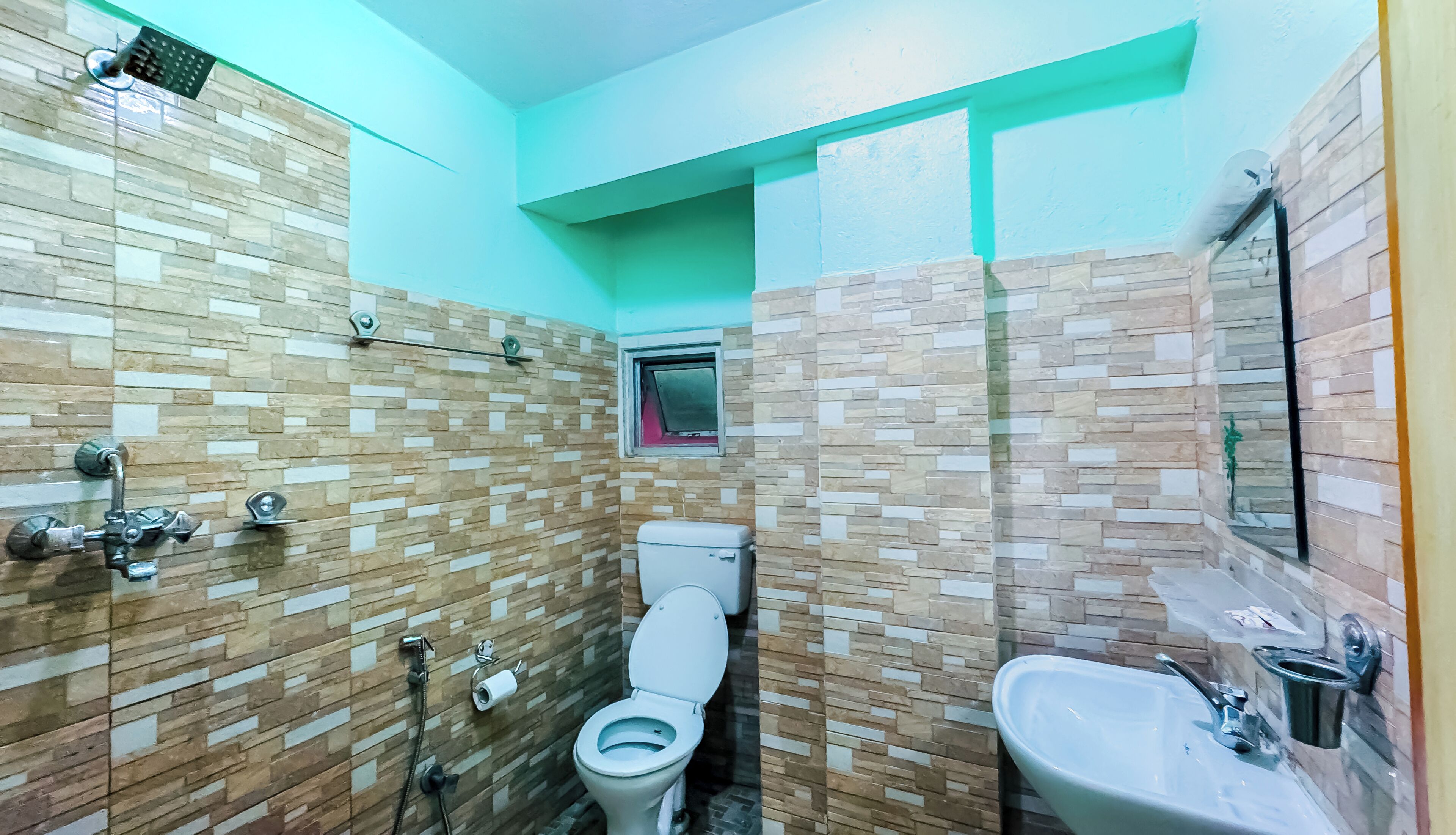 A small bathroom with a toilet, a shower, and a sink.