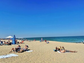 A beach with people sunbathing, umbrellas, and beach chairs. - 1 Block To The Beach -NEW House (Manasquan)