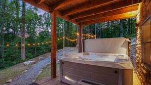 A hot tub under a wooden pergola with a view of a forested area. - Rustic Ravine | Hocking Hills, Hot Tub, Game Room (South Bloomingville)