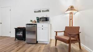 A compact kitchen with a refrigerator, microwave, and a small stove. - Suite Meadow Camp Nelson Lodge# 7 (Springville)