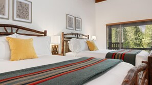 A hotel room with two beds, wooden headboards, white bedding, and a window with blinds. - Suite Meadow Camp Nelson Lodge# 7 (Springville)