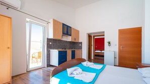 A bedroom with a bed, a bathroom, and a kitchenette. - Bonvie Apartments in Center B3 (Novalja)