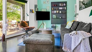 A modern living room with a large TV, a bookshelf, and a cozy seating area. - "Melina" - 900m to the fjord by Interhome (Farsø)