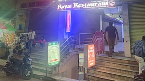 A hotel entrance with a sign for Hotel Roy L and Royal Restaurant. - HOTEL ROYAL RESIDENCY (Shillong)