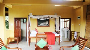 A room with a four-poster bed, wooden furniture, and a leopard painting on the wall. - Peacock Point - Whole Villa 2 Bedroom (Sleeps 4) (Ahangama)