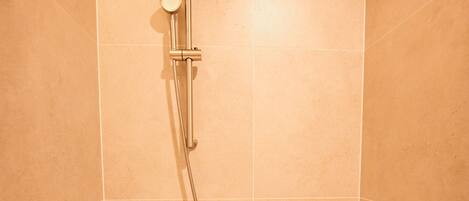 Un baño con bañera, ducha y grifo.