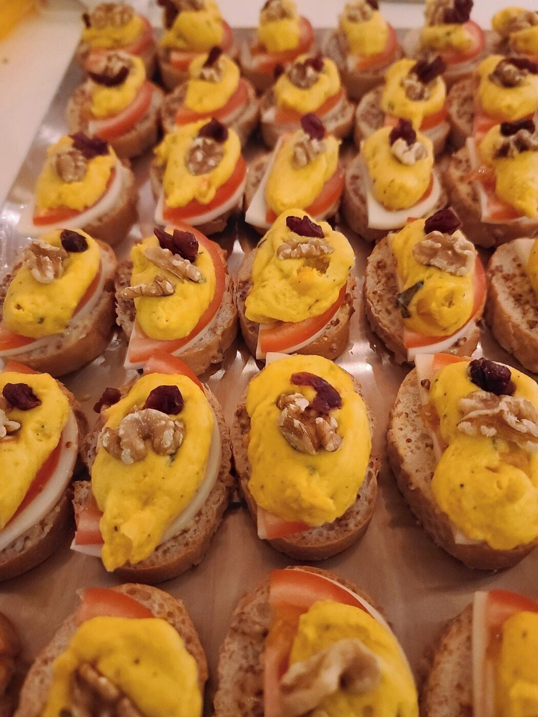 A tray of appetizers with a variety of toppings.