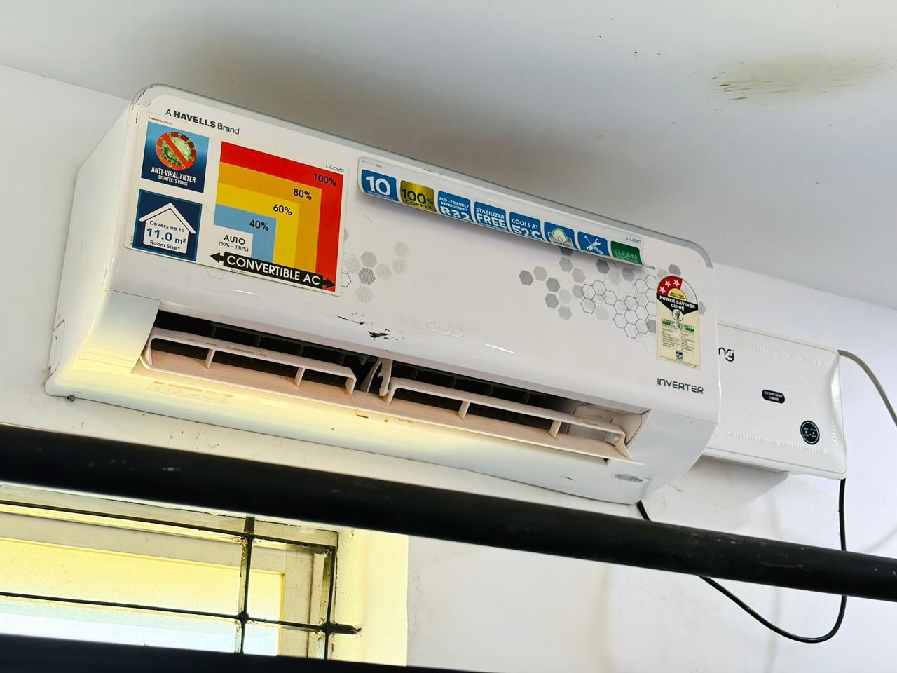 An air conditioning unit with a control panel displaying various settings and certifications.