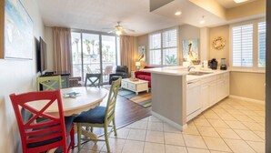 Une chambre d’hôtel compacte comprenant un coin repas, une kitchenette et un balcon avec vue.