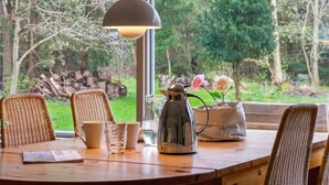 A wooden table with wicker chairs, a kettle, cups, and a vase with flowers. - "Karl" - 4km from the sea by Interhome (Frederiksværk)