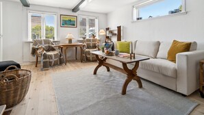 A well-lit living room with a sofa, chairs, a coffee table, and a patterned rug. - "Santuzza" - 100m from the sea by Interhome (Svaneke)