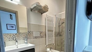 A modern bathroom with a toilet, bidet, and a shower area. - Strategic in the green between Terracina Sabaudia and Circeo (Lazio)