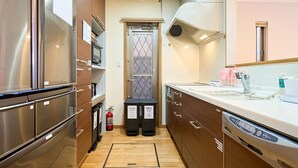 A modern kitchen with stainless steel appliances, wooden cabinets, and a built-in oven.