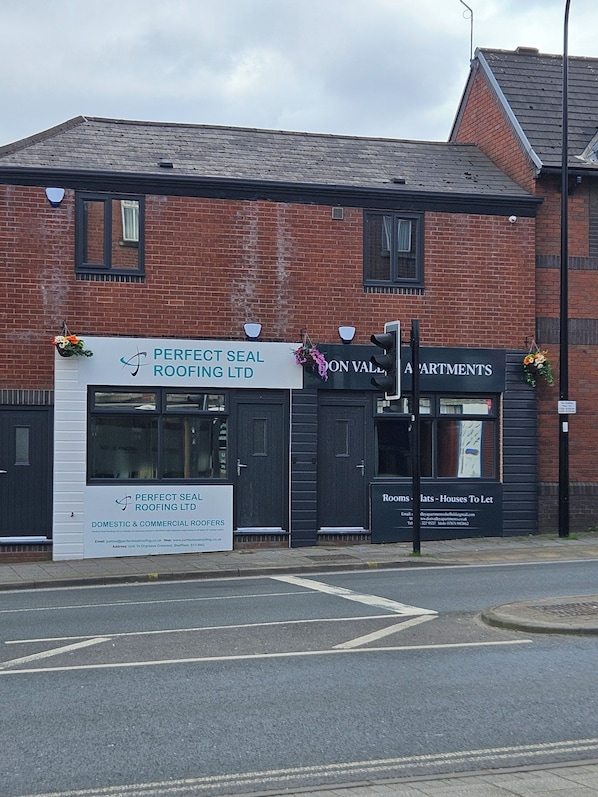 A building with a sign for Perfect Seal Roofing Ltd, indicating it is a commercial roofing service. - Don Valley Apartments (Sheffield)