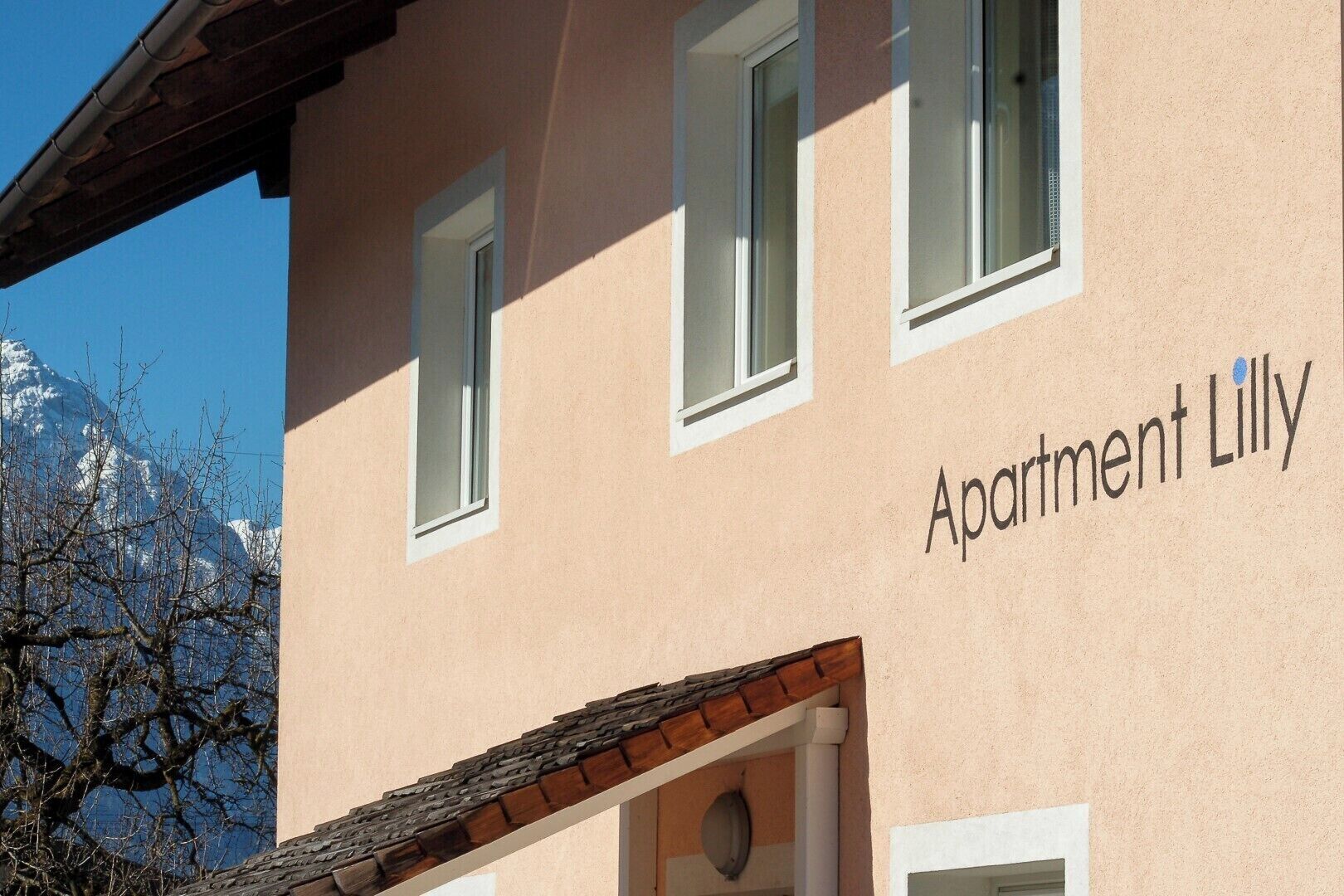 A building with the text "Apartment Lilly" on its facade.