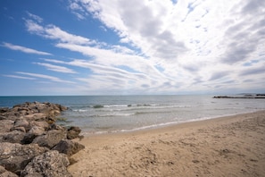 A beach with rocky shoreline and clear blue sky. - Sandy Beach, Palavas-les-flots, Plage (Palavas-les-Flots)