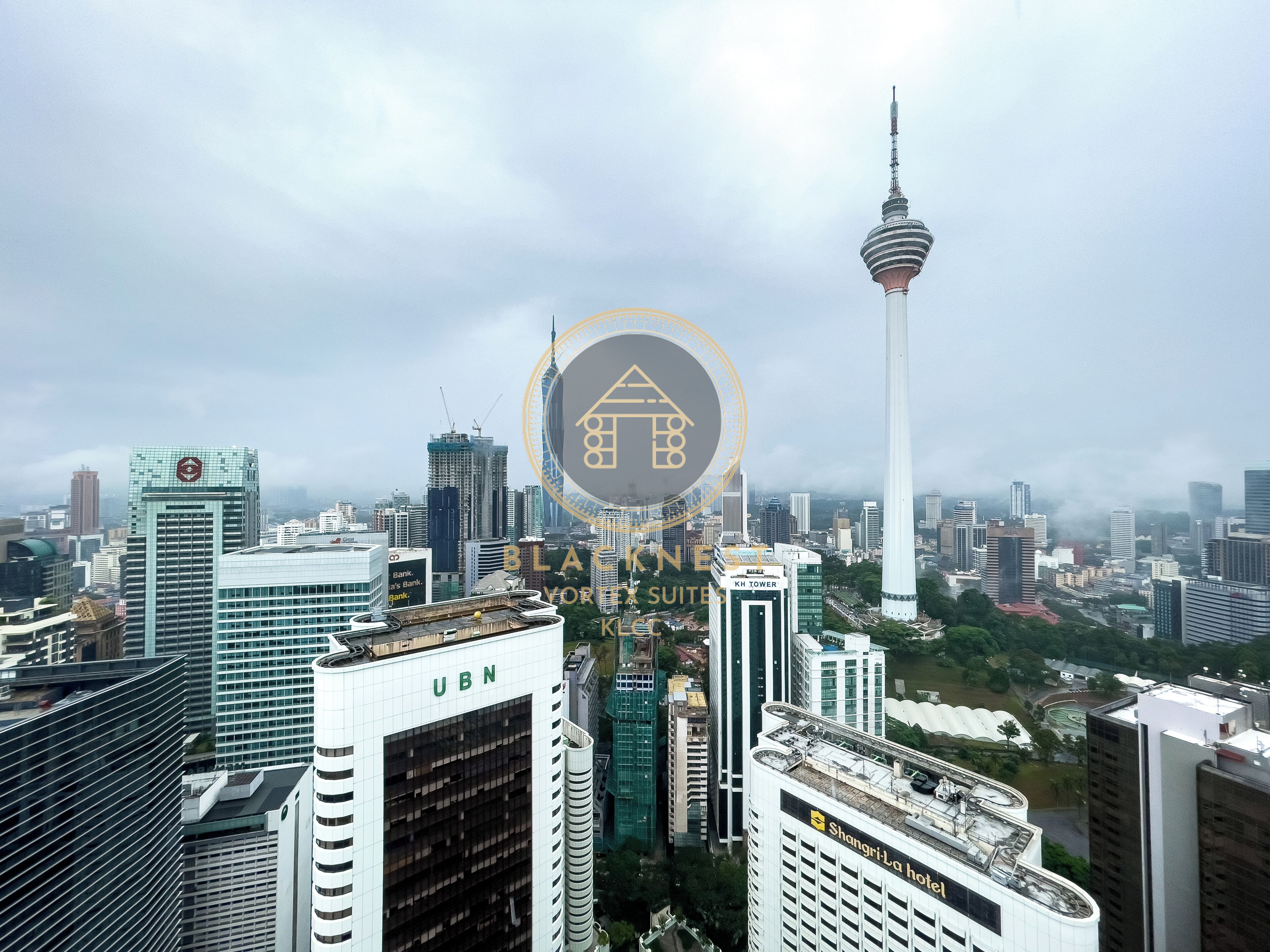 A cityscape with modern high-rise buildings, including a prominent tower and a building labeled "UBN".