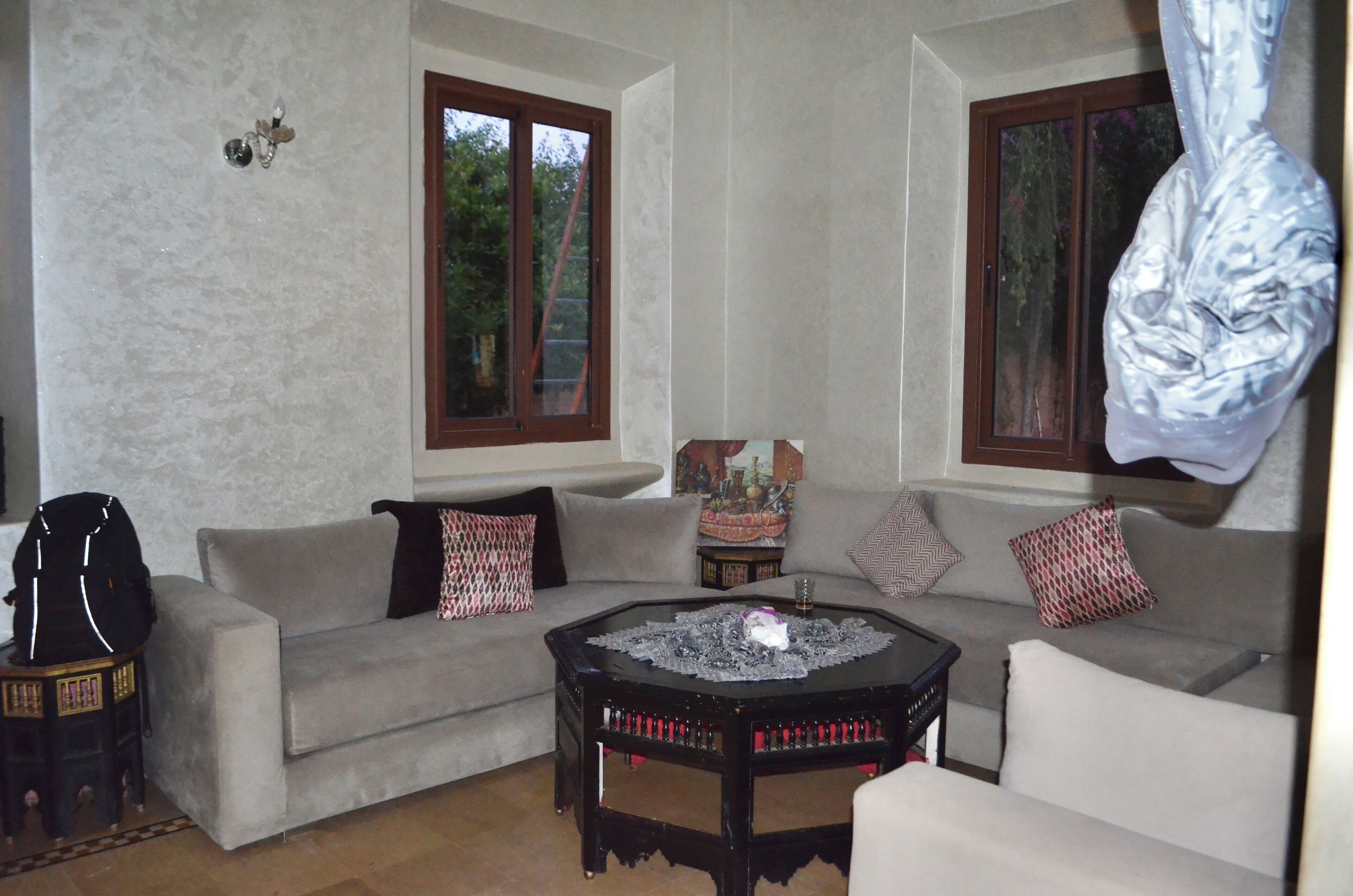 A living room with a sofa, a coffee table, and a guitar.
