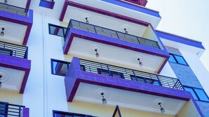A multi-story building with balconies, railings, and windows. - NN GUEST HOUSE  (Bonaberi)