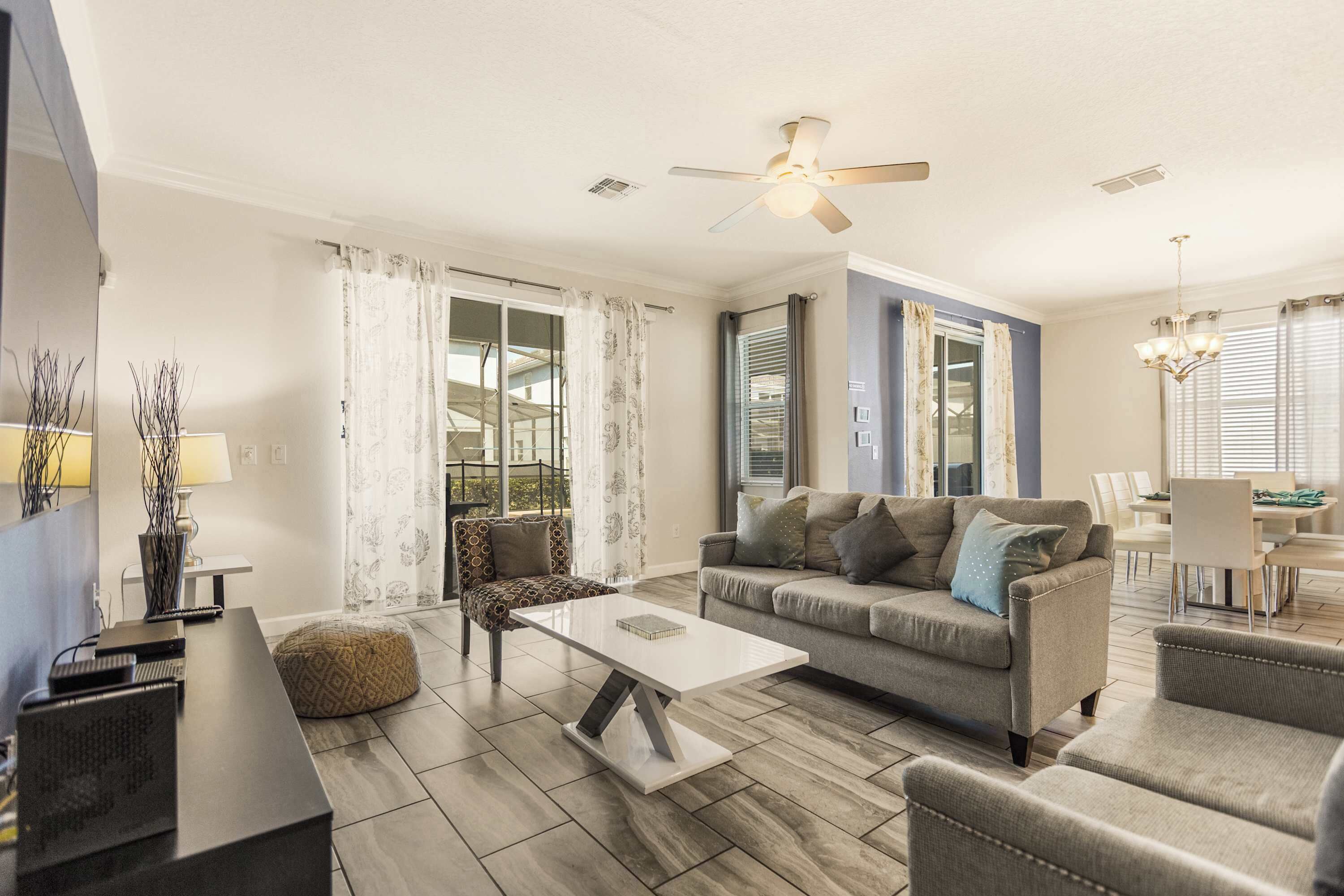 Relax in this stylish living room with ample seating and natural light, perfect for gatherings and cozy evenings.