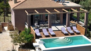 A modern villa with a rooftop pool, sun loungers, and a covered outdoor seating area. - Astarte Villas - Stilvi 4 Bedroom Private Villa With Pool (RV3V+9Q3 Zakynthos, Greece)