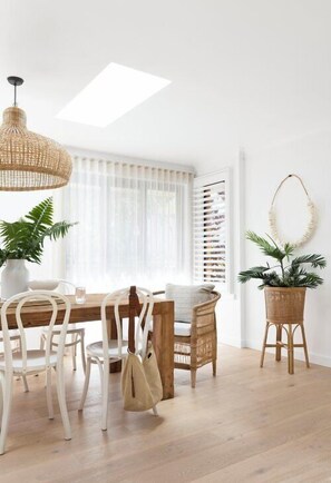 Enjoy meals in this inviting dining area with a wooden table and comfortable seating for two.