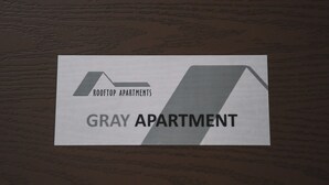 A sign for Rooftop Apartments' Gray Apartment. - Rooftop Grey Apartment at Rustaveli Avenue (T'bilisi)