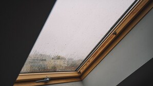 A skylight with a wooden frame and a metal handle. - Rooftop Grey Apartment at Rustaveli Avenue (T'bilisi)