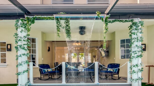 A pool area with a water feature, seating, and a covered patio. - Golden Globe - Luxury on the Canal With Pool spa (Cape Coral)