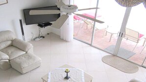 A modern living room with a sofa set, a coffee table, and a TV. - Altaira - top Location Lake View Pool Spa 4 Bed (Naples)