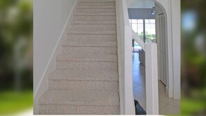 A staircase with beige carpet, white walls, and a white railing. - Altaira - top Location Lake View Pool Spa 4 Bed (Naples)