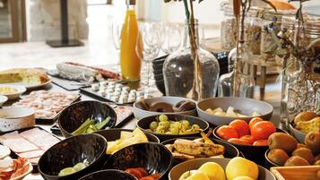 A buffet table with various food items and a decorative centerpiece.