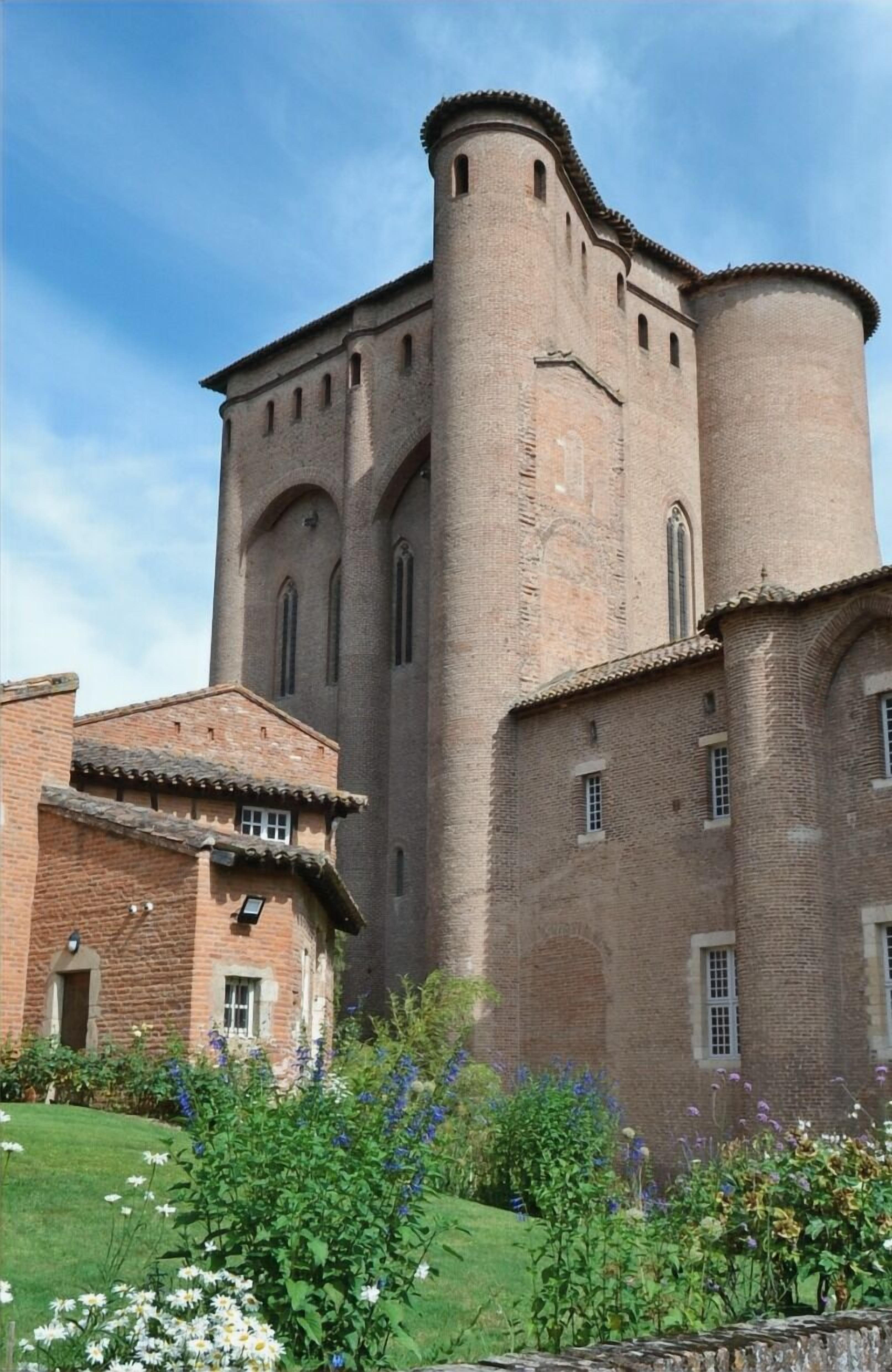 A historic building with a prominent tower and a smaller adjacent structure.