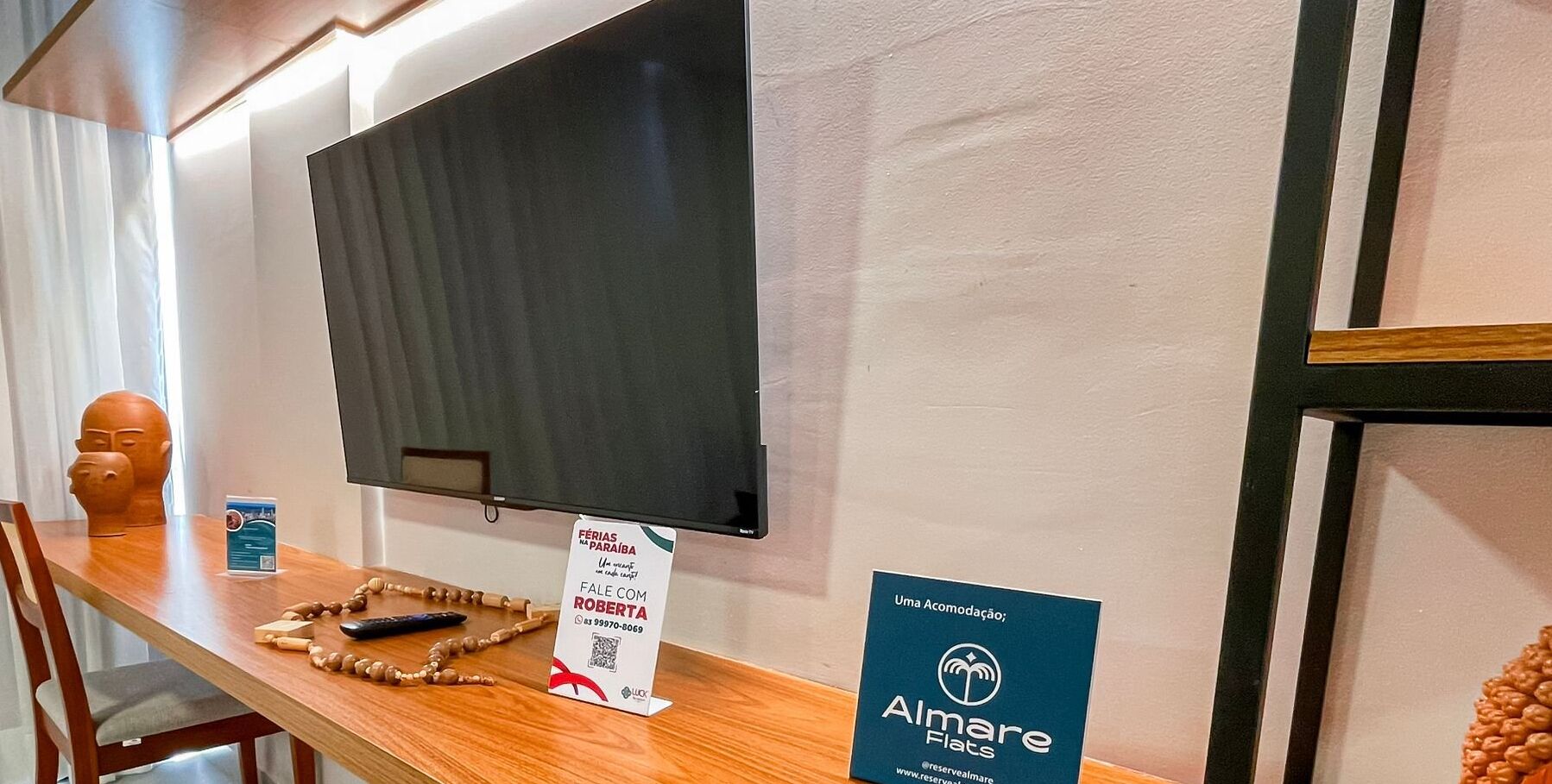 A reception area with a wooden desk, a television, and informational signs.