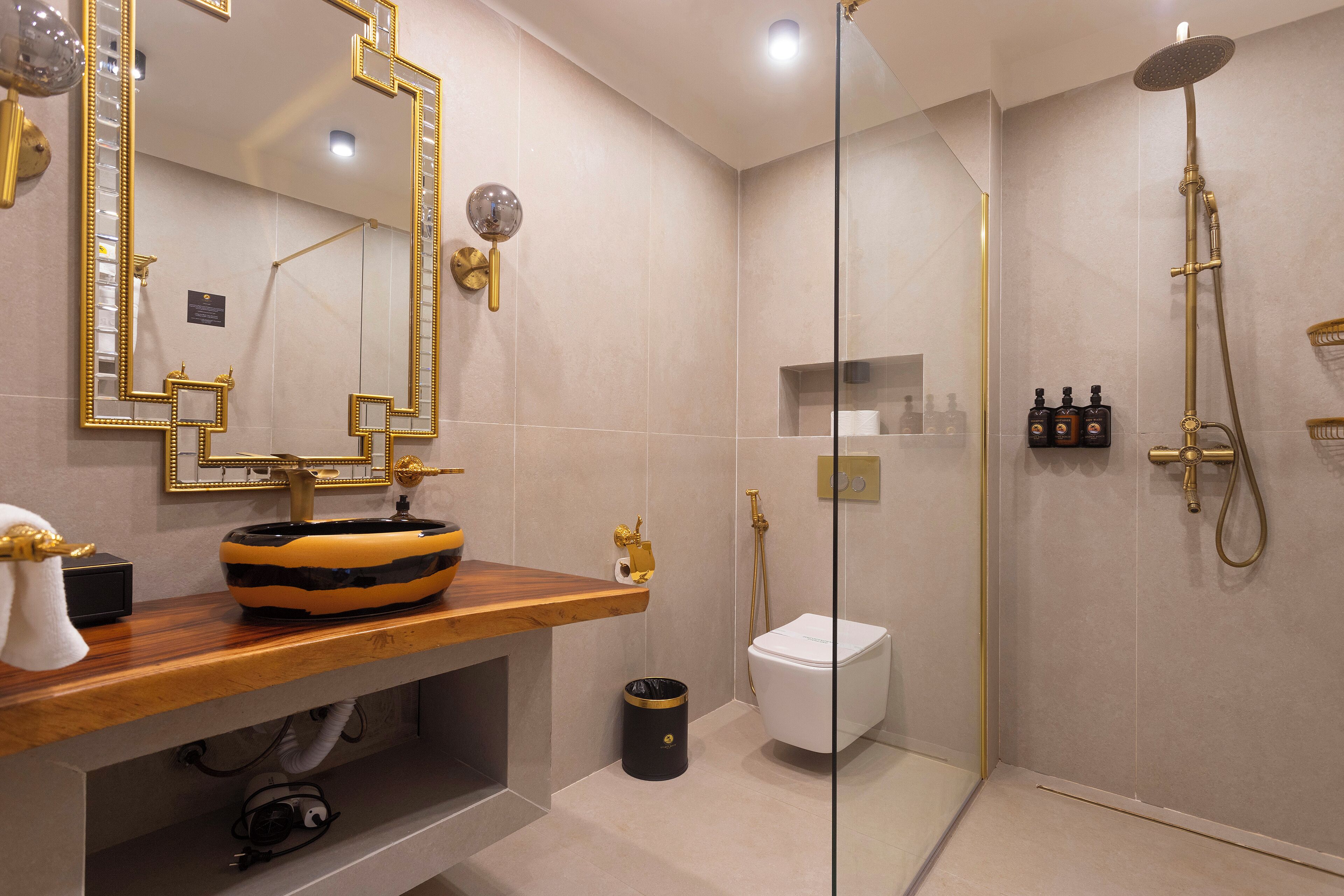 A modern bathroom with a vanity, a large mirror, a shower, and a toilet.