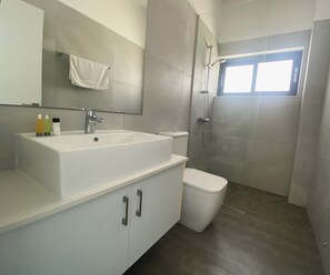 A modern bathroom with a large white sink, a toilet, and a shower area. - DPS03 - A Luxury Villa Nissi Pearl - An ultimate stay in Ayia Napa!  (Ayia Napa)