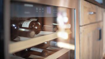 A wine refrigerator with multiple shelves containing bottles.