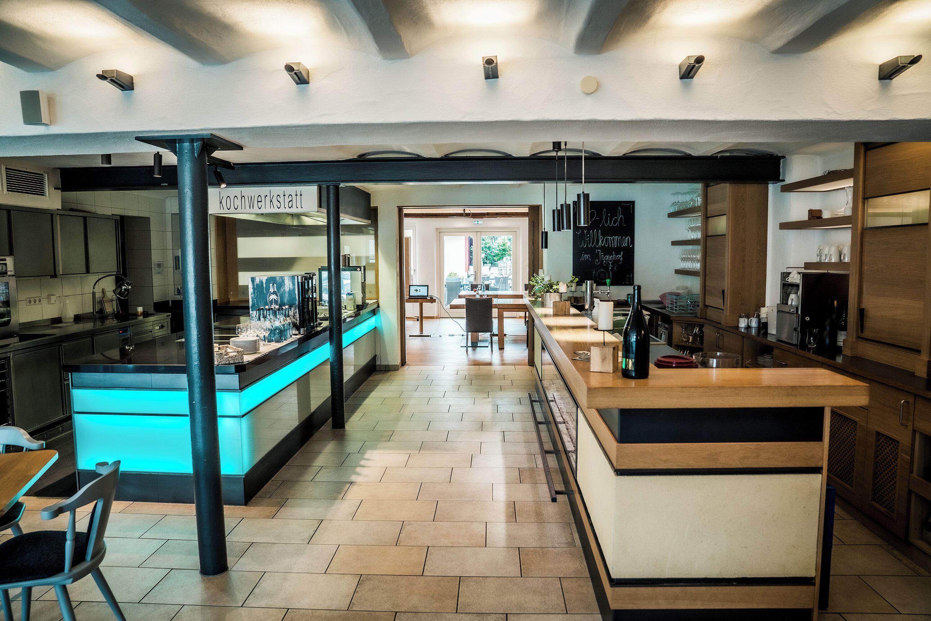 A modern kitchen with a central island, a bar area, and a seating space.