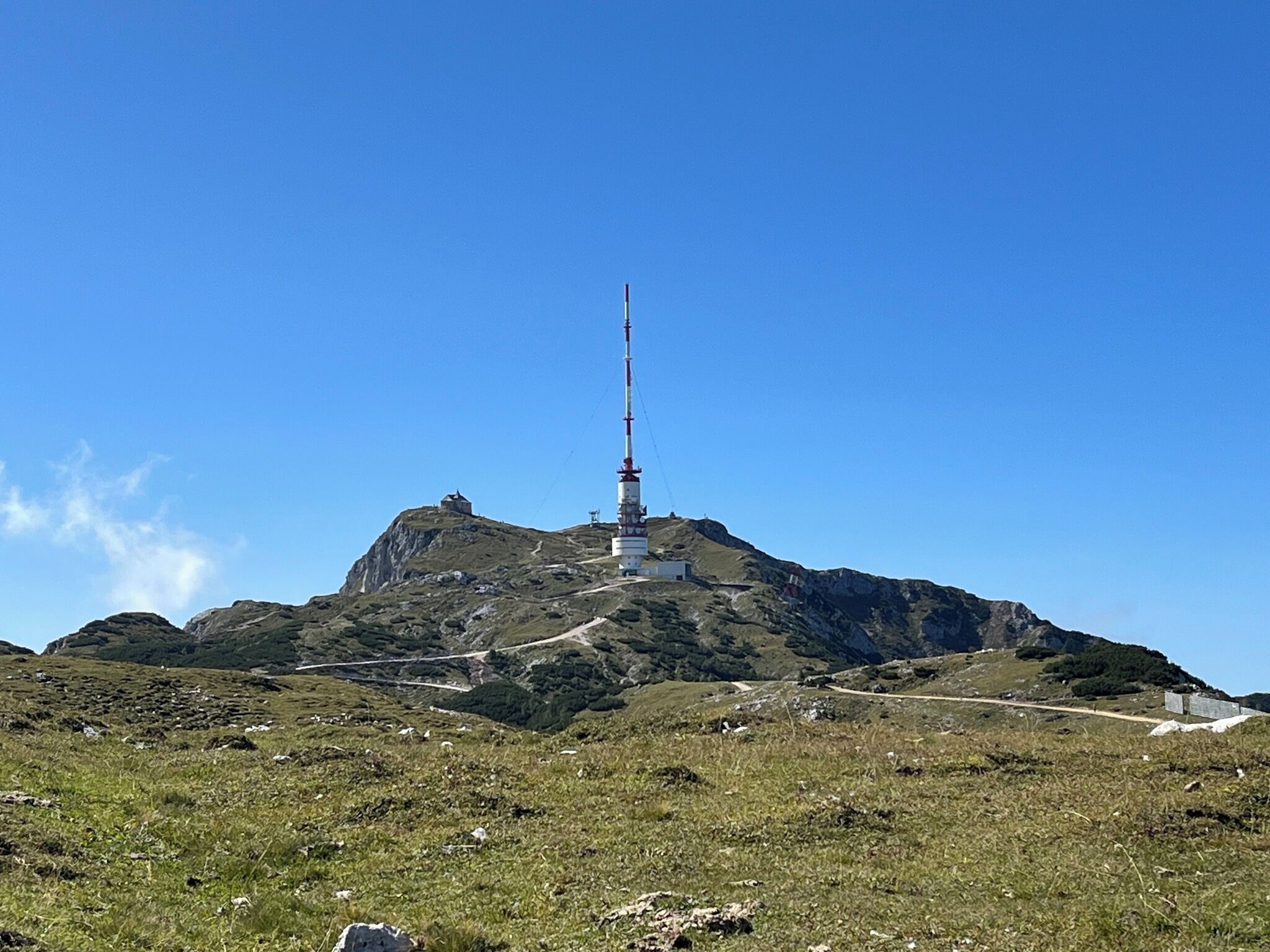 A mountain with a tall communication tower on top.