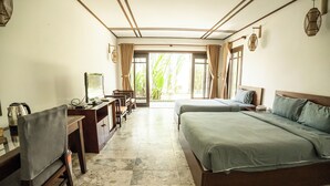 A hotel room with a bed, desk, chair, and a television. - Riverside Bamboo Resort - Hoi An (Da Nang)
