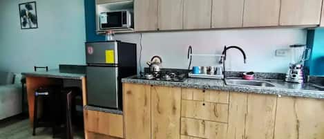 Microwave, coffee/tea maker, cookware/dishes/utensils, kitchen islands