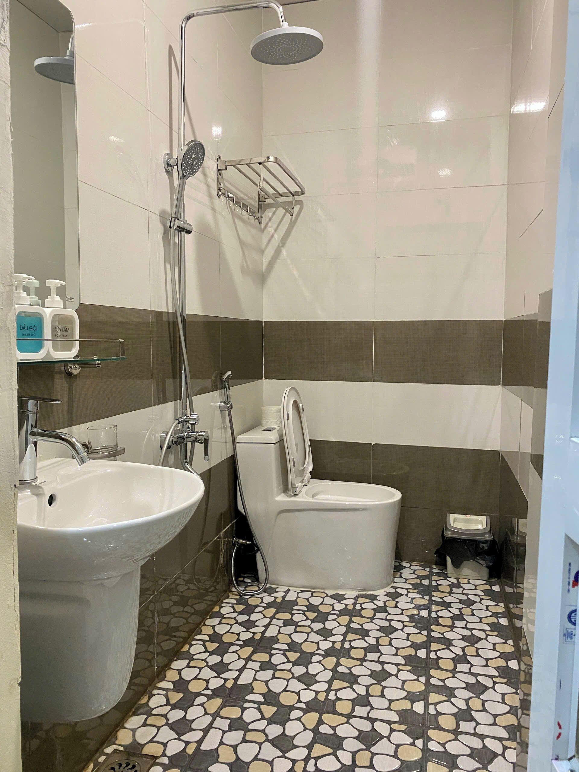 A bathroom with a sink, toilet, and shower.