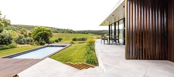 Modern twin-villa with shared pool in middle of nature.