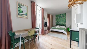 A bedroom with a bed, a desk, and a chair.