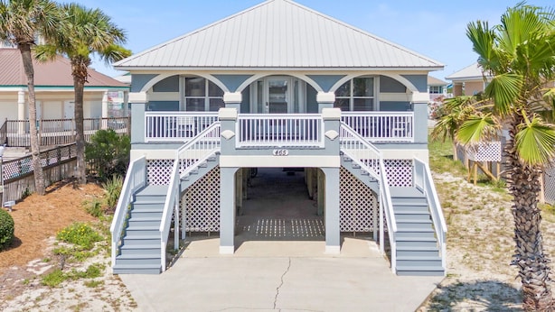 A two-story beach house with a covered entrance, white railings, and a number '465' on the front. - ⭐Short, Easy Walk to Beach-2 Community Pools-Balcony with Views-Harbor Light⭐ (Gulf Shores)