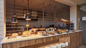 A buffet setup with various food items and a counter with plates.